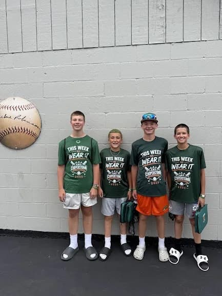 Hurricanes players at the baseball wall in the village